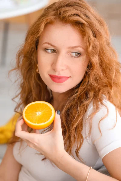 Beautiful Young Woman Eating Fresh Orange Home — Stock Photo, Image