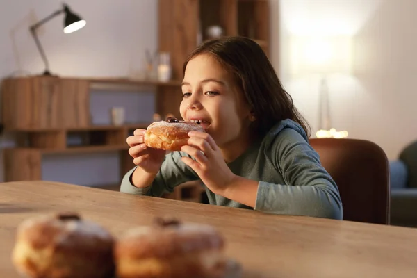 Happy Little Girl Eating Tasty Donuts Hannukah Home — Stock Photo, Image