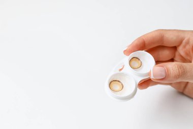 Konteynırı kontak lensli bir kadın tutuyor, yakın plan.