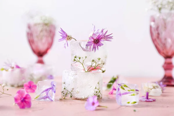 Glasses Beautiful Flowers Frozen Ice Color Background — Stock Photo, Image