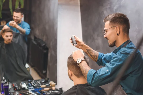 stock image Professional hairdresser working with client in barbershop
