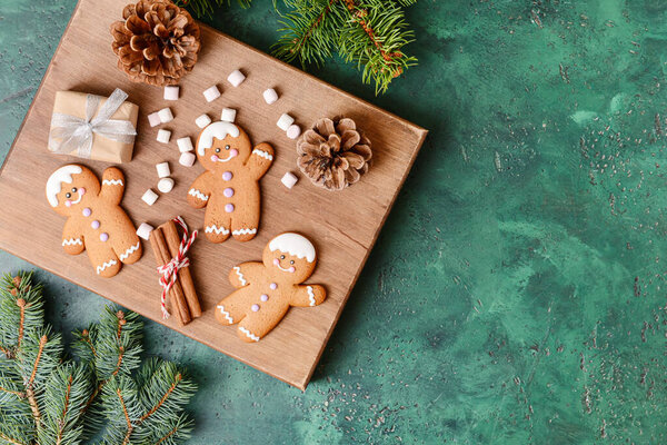 Christmas composition with gingerbread cookies on color background