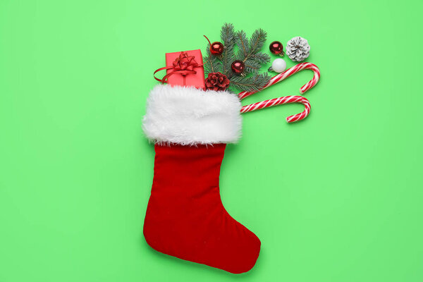 Composition with Christmas sock on color background