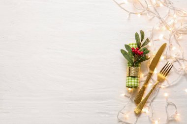 Beyaz ahşap arka planda ökseotu olan güzel bir Noel masası.