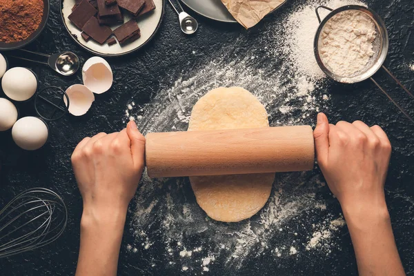 Woman preparing bakery on table, top view