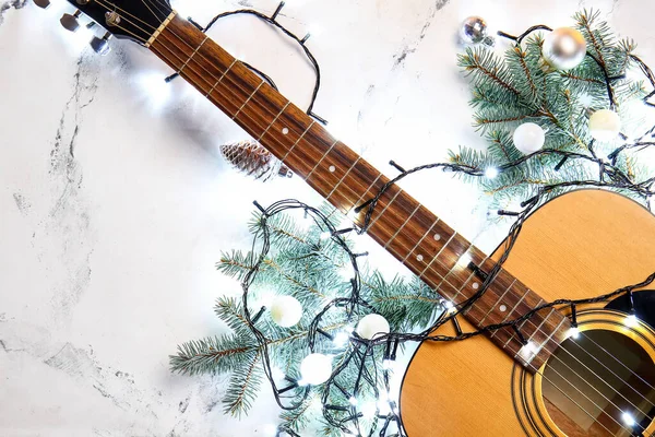 光の背景にクリスマスライトや装飾とギター — ストック写真