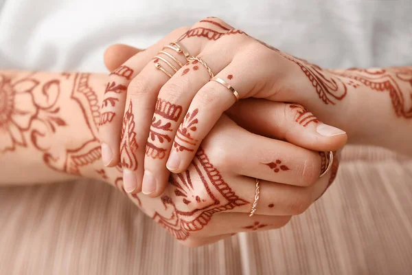 Beautiful woman with henna tattoo on hands, closeup