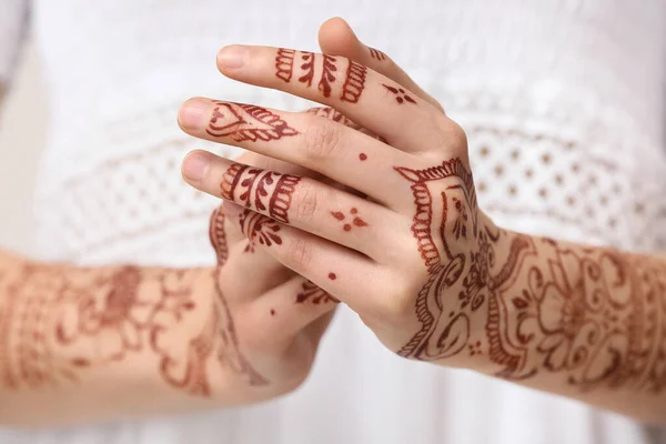 Beautiful woman with henna tattoo on her hands, closeup