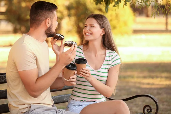 Young Couple Eating Sweet Donuts Drinking Coffee Outdoors — Stock Photo, Image