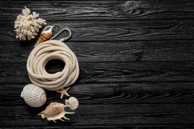 Yuvarlak ipli kompozisyon ve koyu ahşap arka planda deniz dekoru.