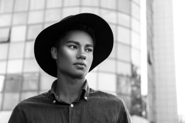 Afro-Amerikalı bir adamın açık havada siyah beyaz portresi.