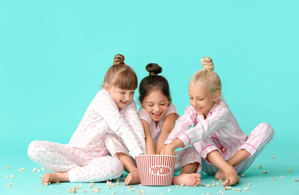 Cute Little Girls Pajamas Eating Popcorn Color Background — Stock Photo, Image