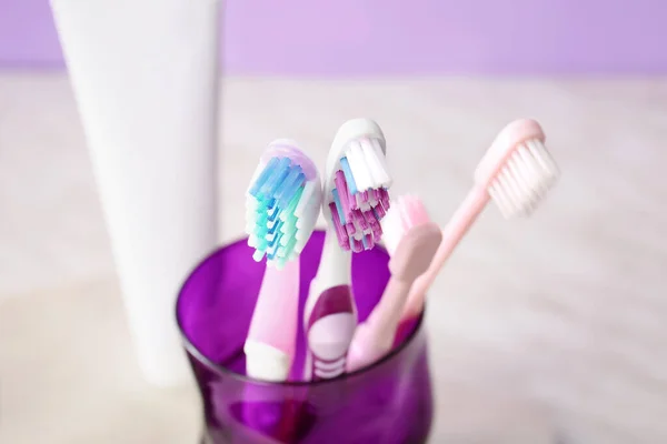 Holder with toothbrushes on table