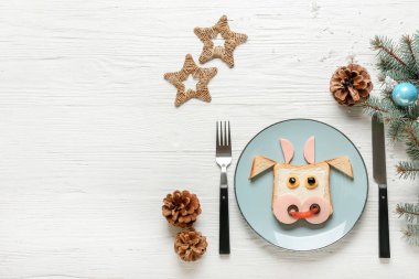 Yemek masasında boğa şeklinde lezzetli bir sandviç.