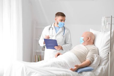 Doktor ve kıdemli adam klinikte kemoterapi görüyorlar. Prostat kanseri farkındalığı