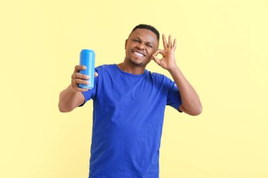 Arkaplanda sodası olan yakışıklı Afro-Amerikalı adam.