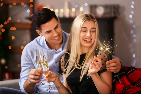 Happy Young Couple Sparklers Champagne Celebrating Christmas Home — Stock Photo, Image