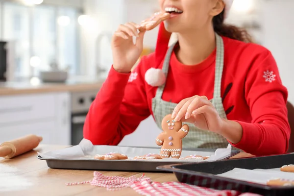 Young Woman Eating Tasty Homemade Gingerbread Cookies Kitchen Christmas Eve — Stock Photo, Image