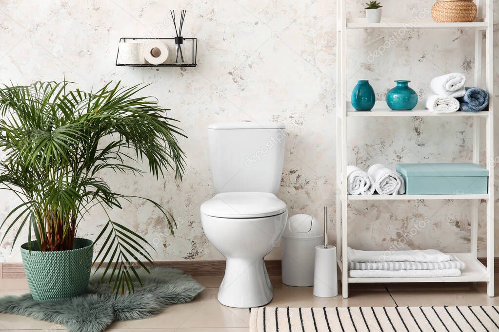 Modern toilet bowl in interior of bathroom