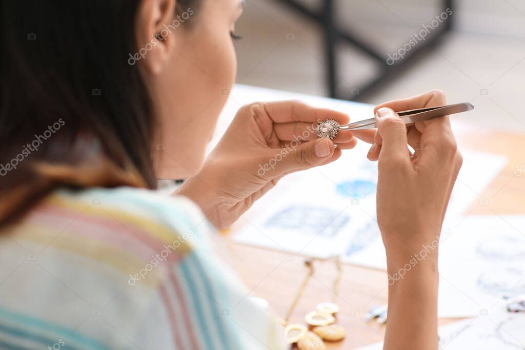 Female jewelry designer working in office, closeup