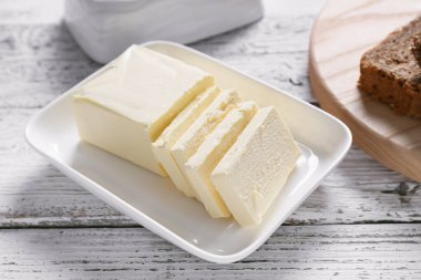 Ahşap masada taze tereyağlı tabak.