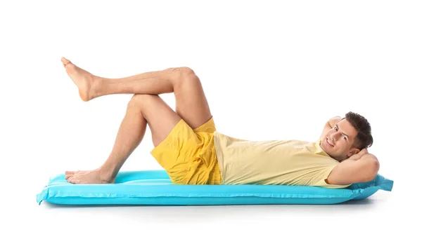 年轻男子躺在有白色背景的充气床垫上 — 图库照片