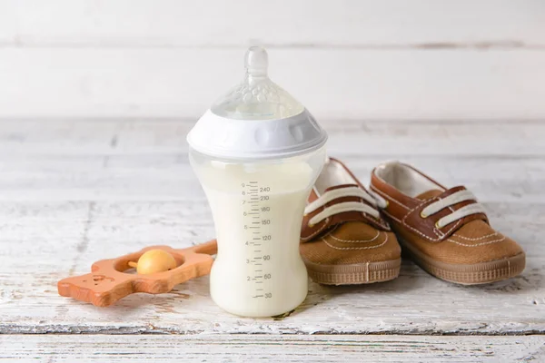 Bottle Milk Baby Booties Toy Table — Stock Photo, Image