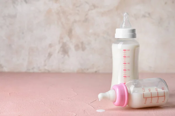 Bottles of baby milk formula on table