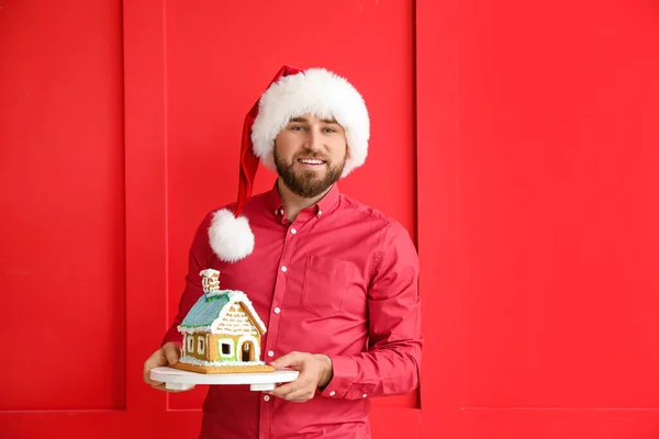 Happy Young Man Gingerbread House Color Background Christmas Celebration — Stock Photo, Image