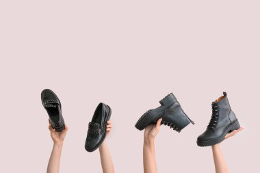 Beyaz arka planda şık ayakkabılı eller