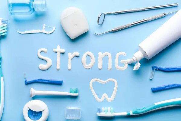 Set for oral hygiene and word STRONG on color background