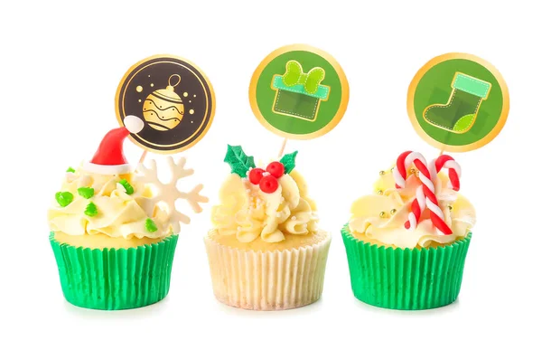 Tasty Christmas cupcakes on white background