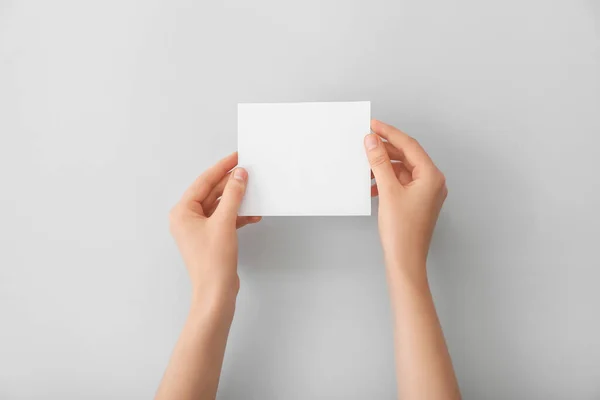 Mãos Femininas Com Papel Branco Sobre Fundo Claro — Fotografia de Stock