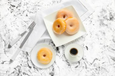 Tatlı çörekler ve arka planda bir fincan kahve.