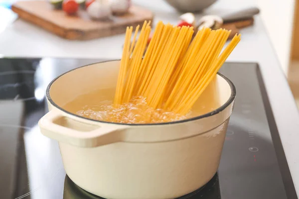 Pasta boiling in cooking pot on electric stove