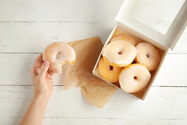 Female Hand Tasty Donuts Wooden Background — Stock Photo, Image