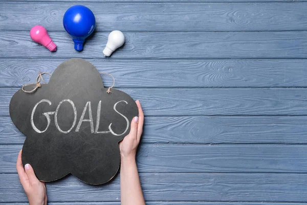 Female Hands Light Bulbs Word Goal Wooden Background — Stock Photo, Image