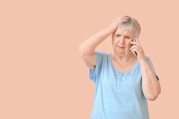 Stressed Senior Woman Talking Mobile Phone Color Background — Stock Fotó