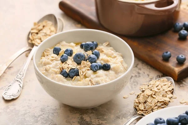 Schüssel Mit Leckerem Haferbrei Und Blaubeeren Auf Dem Tisch — Stockfoto