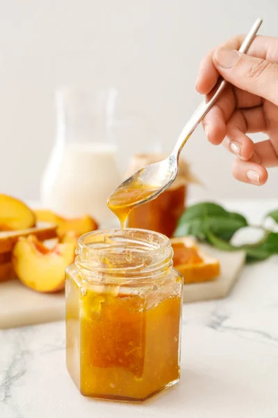 Female Hand Spoon Jar Peach Jam Table — Stock Photo, Image