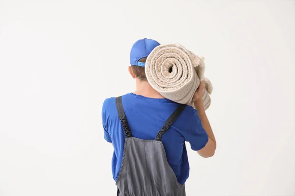 Trabajador Con Alfombra Enrollada Sobre Fondo Blanco —  Fotos de Stock