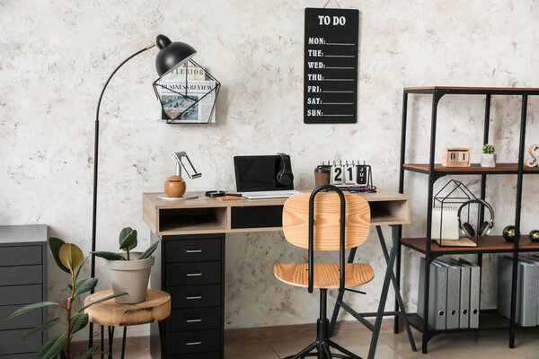 Modern workplace with laptop and to-do list in office