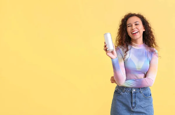 Beautiful African-American woman with soda on color background