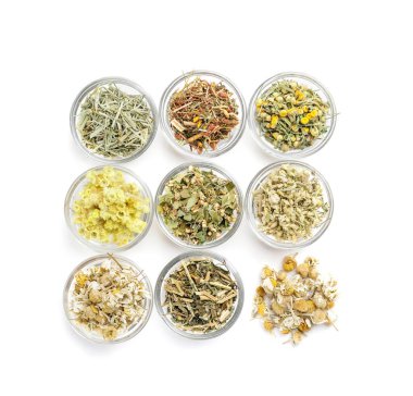 Beyaz arka planda farklı otlar bulunan kaseler
