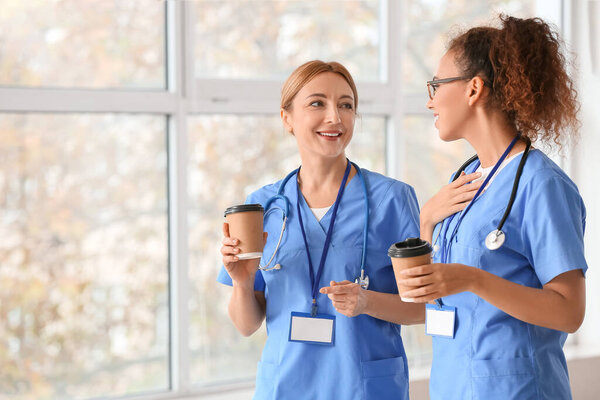 Female doctors drinking coffee in clinic