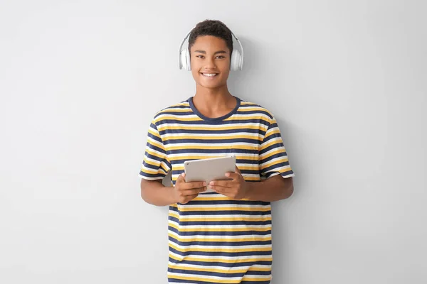 Teenage African American Boy Tablet Computer Headphones Light Background — Stock Photo, Image