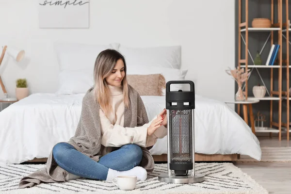 Young Woman Warm Clothes Sitting Electric Heater Home Concept Heating — Stock Photo, Image