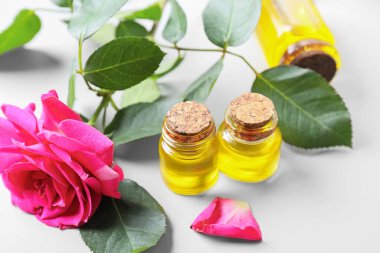 Işık arka planında çiçek yağı olan şişeler.