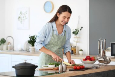 Kadın mutfakta lezzetli bir çorba pişiriyor.