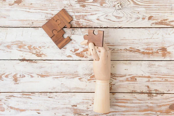 Wooden Human Hand Puzzle Pieces Table — Stock Photo, Image